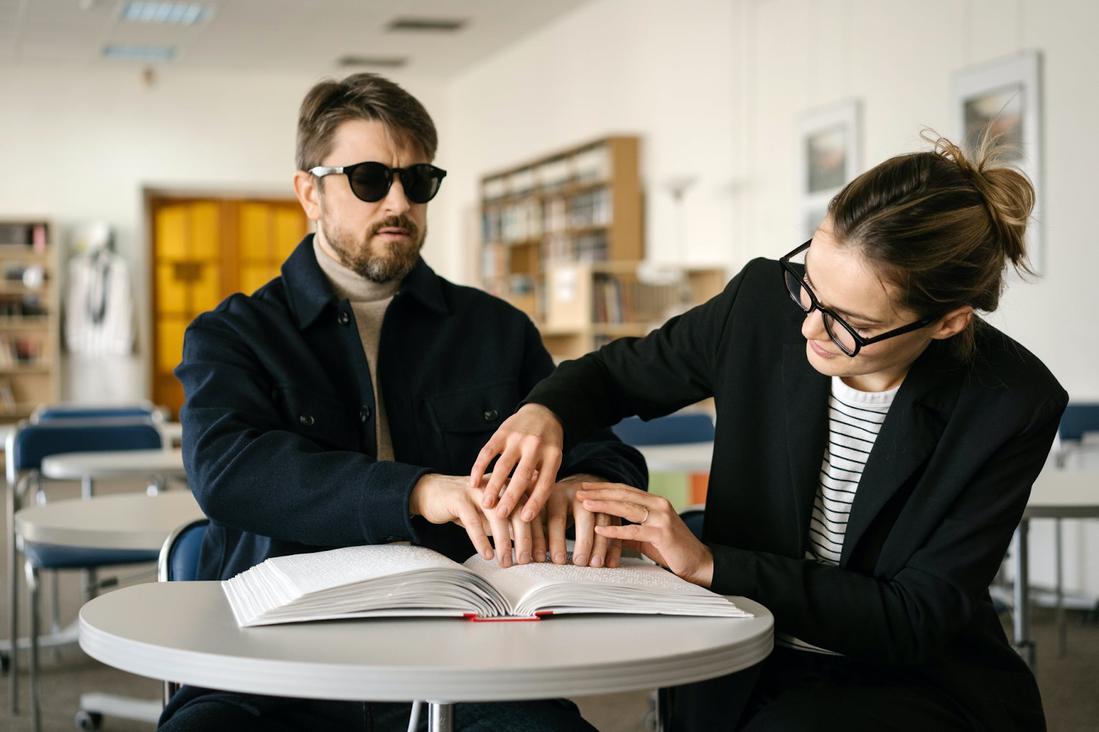 Man learning to read braille